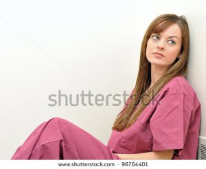stock-photo-tired-female-nurse-or-physician-leaning-against-a-white-wall-looking-off-frame-96704401